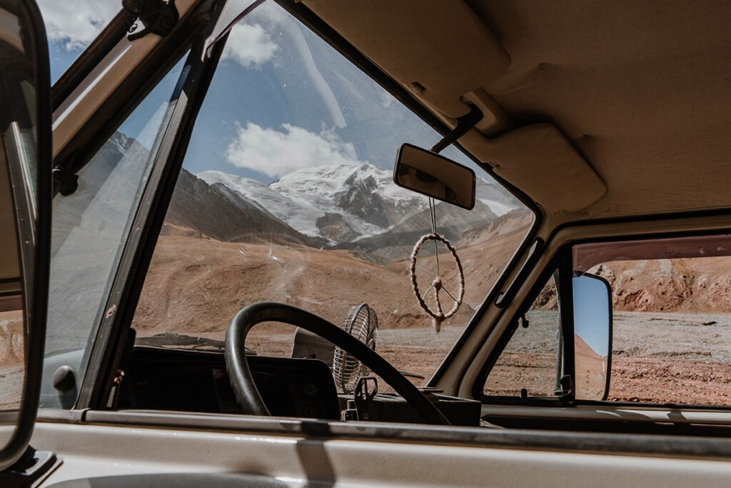Blick aus dem Cockpit von VW T3 Camper auf die Berge vom Pamir-Gebirge.